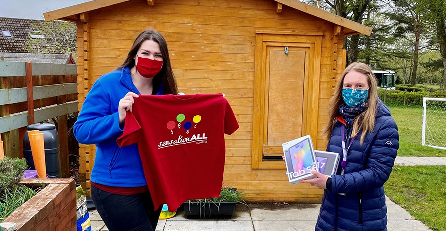 Susan Low (right) presents Katie McNutt with tablets